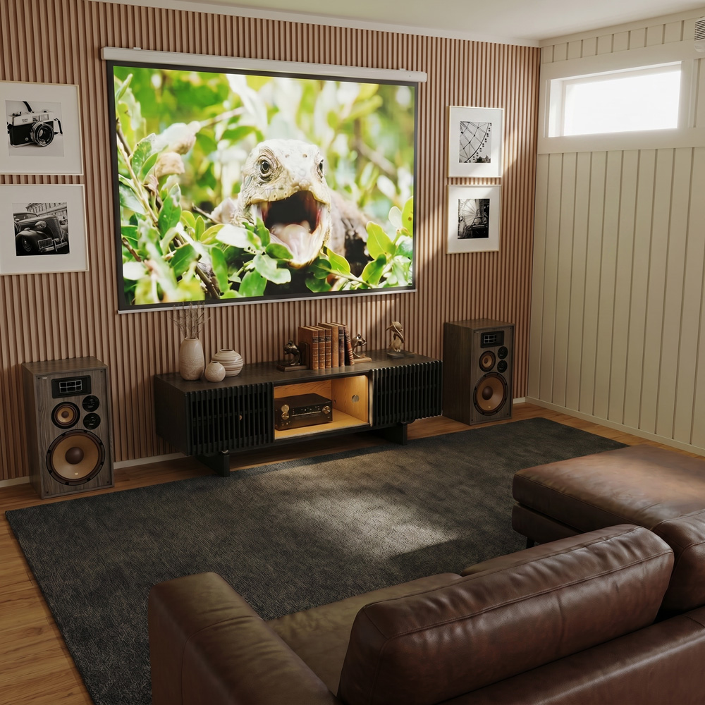 Small home entertainment room with a large projector screen, wooden media console, vintage speakers, and brown leather sectional sofa.