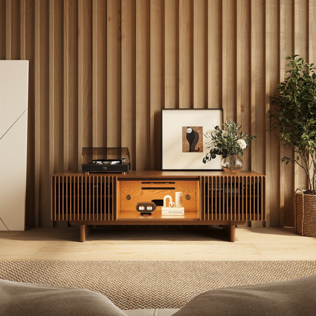 Mid-century modern wooden TV stand with slatted cabinet doors, open shelving, and a warm walnut finish in a naturally lit living room.