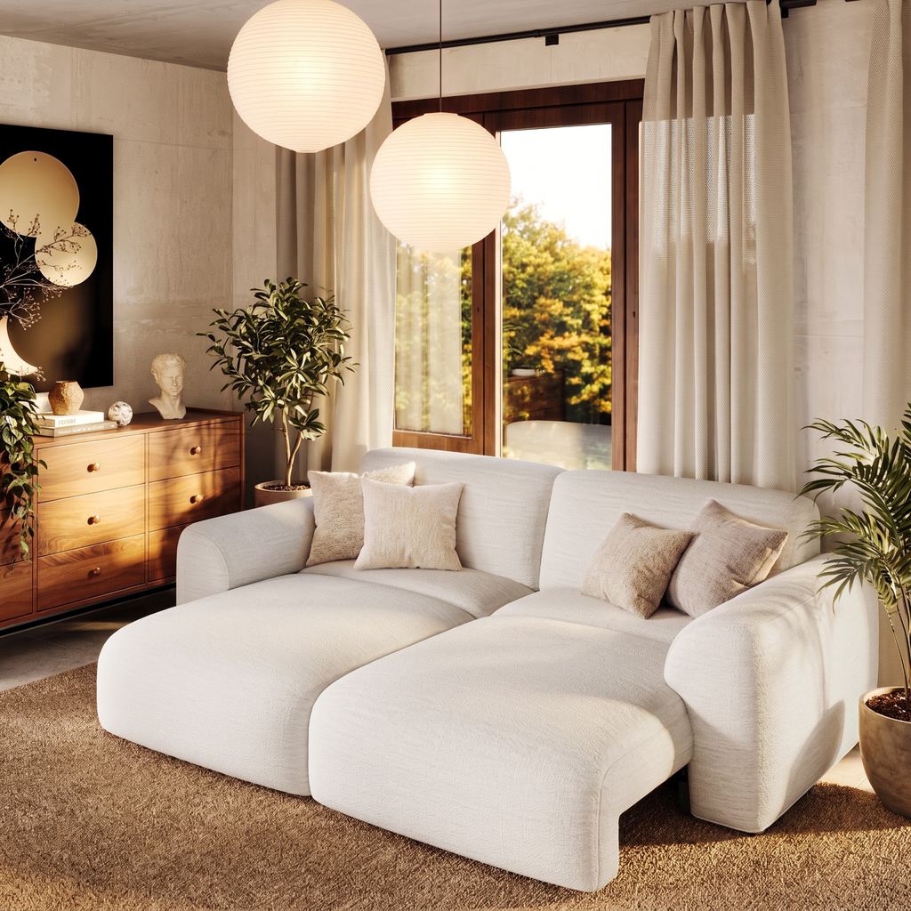 Modern kid-friendly living room with a spacious cream modular sofa, rounded edges, soft neutral decor, and an open layout.