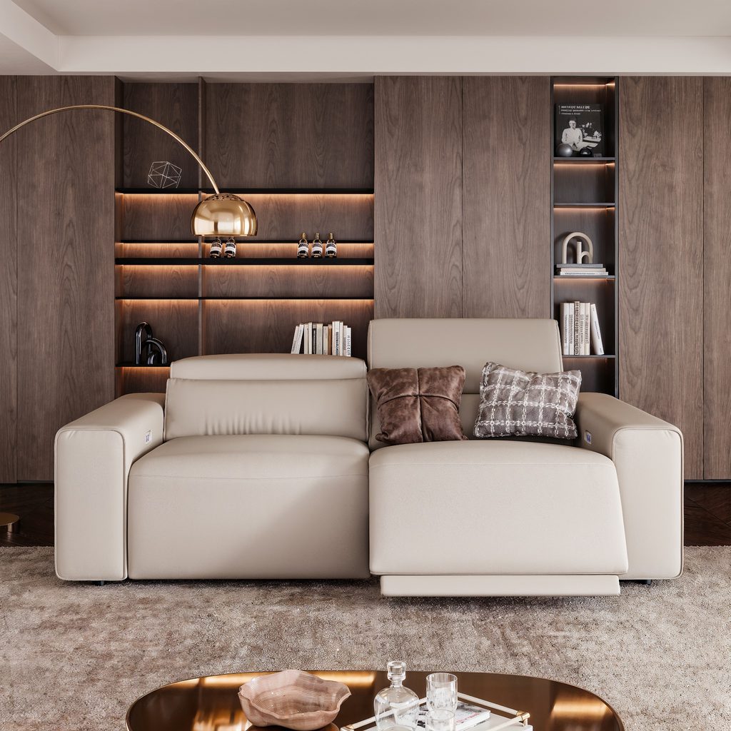 Modern living room with a cream power sofa bed featuring an extended seat, walnut wall panels, built-in shelves, and a gold arc floor lamp.