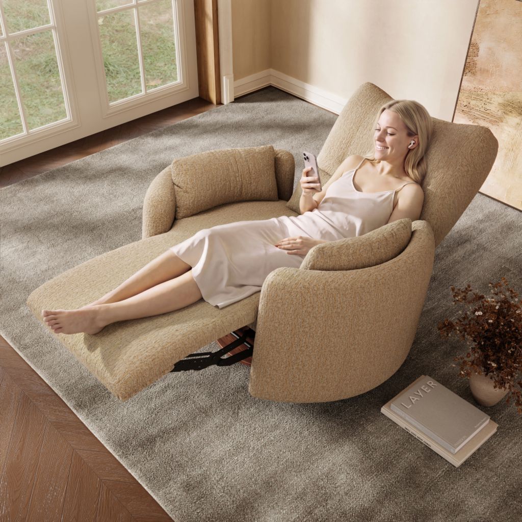 Woman relaxing in a beige upholstered recliner chair with an extended footrest, using her phone in a bright living room.