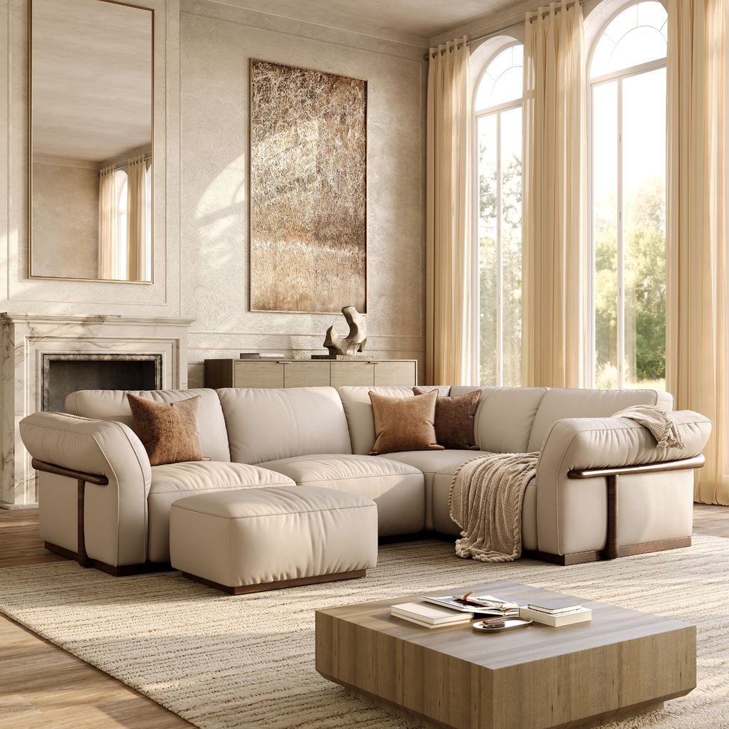 Spacious modern living room with a large cream sectional sofa, ottoman, coffee table, fireplace, and floor-to-ceiling windows.
